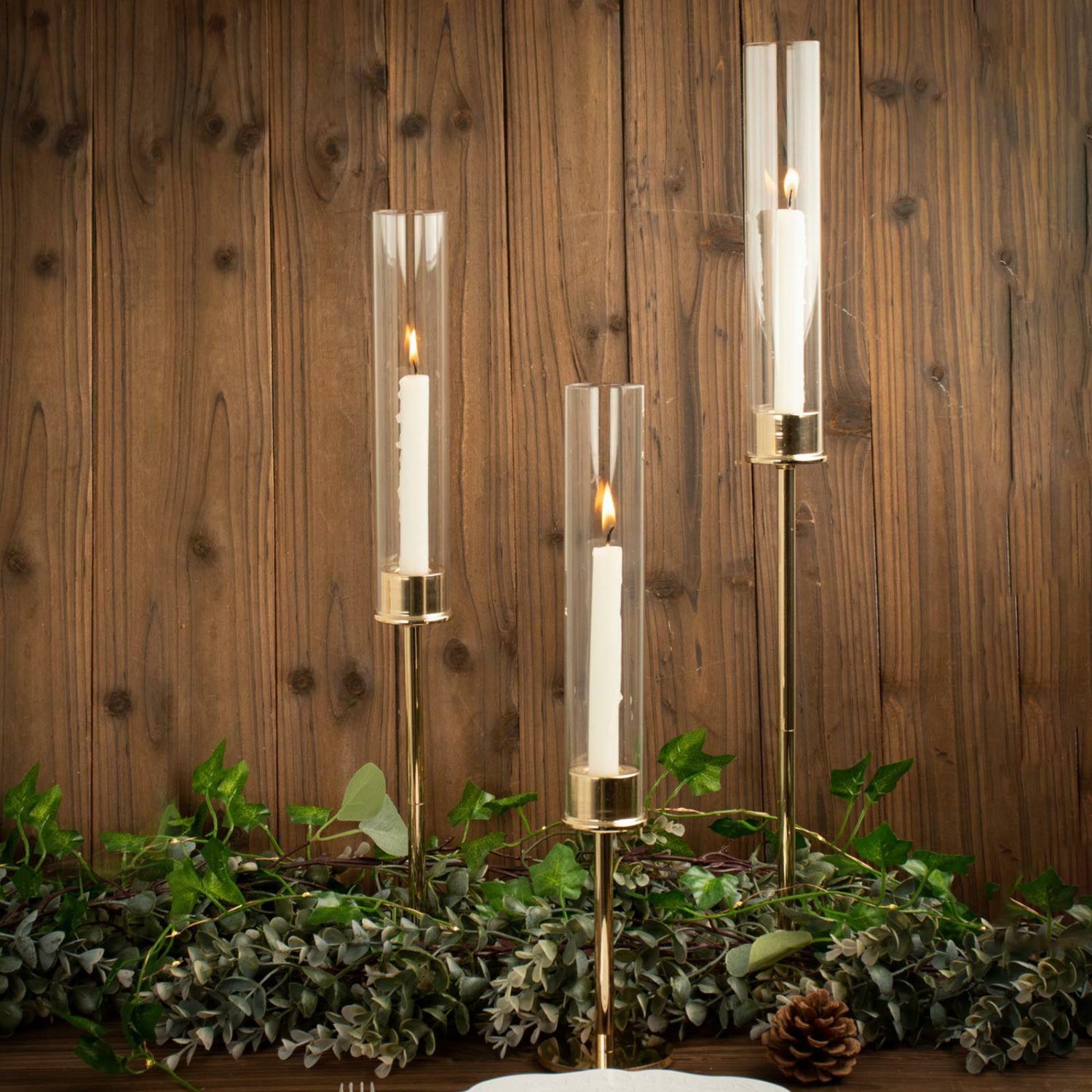 Metal Candle Holders | Set of 3 Tall Gold Metal Clear Glass Taper Candlestick Holders, Hurricane Candle Stands With Glass Chimney Candle Shades 16″, 20″, 24″ Candelabra Gold